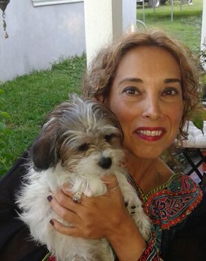 Mercy, who reads the support messages, holding one of her dogs at home